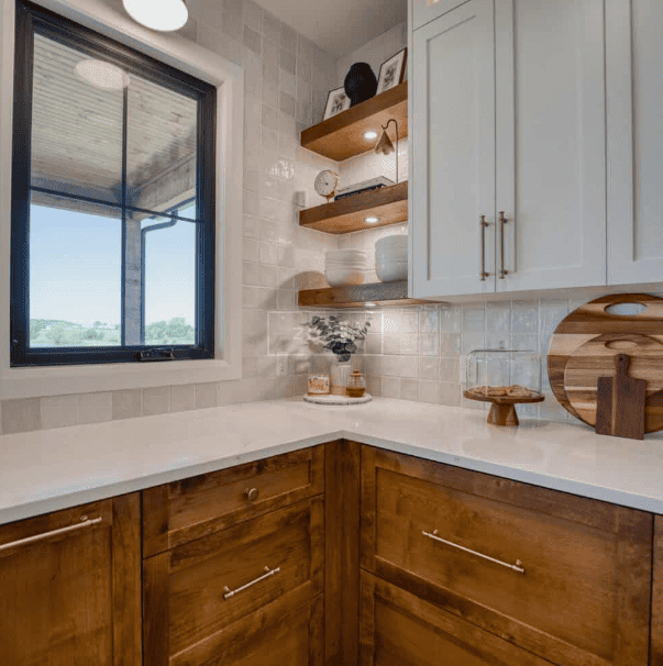 Homeowner reviewing cabinet design plans to avoid common kitchen remodel mistakes