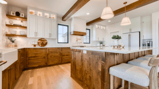 Open-concept kitchen featuring coordinated wood and white cabinets that match the home’s overall interior décor